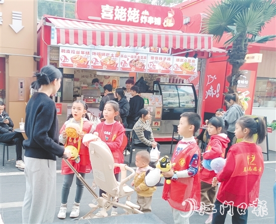 統(tǒng)一身著志愿者服裝的孩子們化身“愛心小掌柜”，向顧客推銷商品。