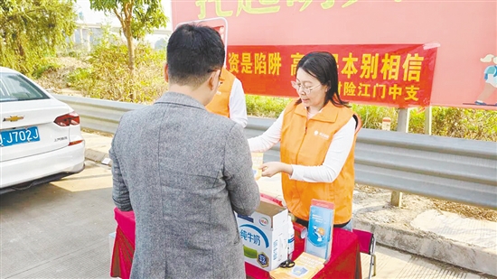 工作人員向過往司乘人員普及反詐知識。